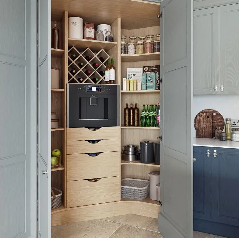 Kitchen pantry with open doors showing shelving and drawers